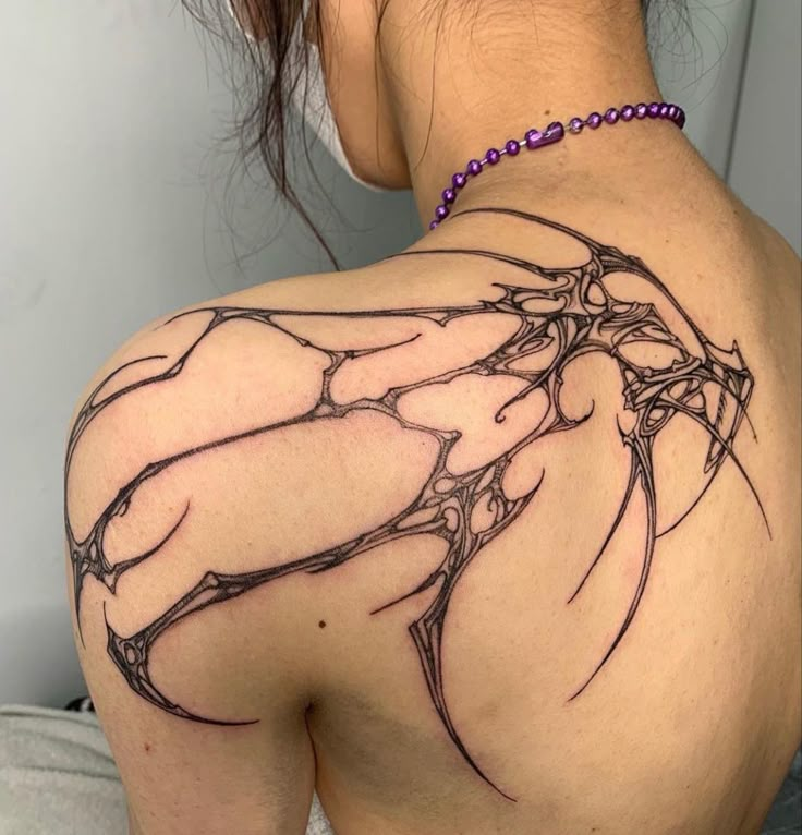 a woman with a tattoo on her back