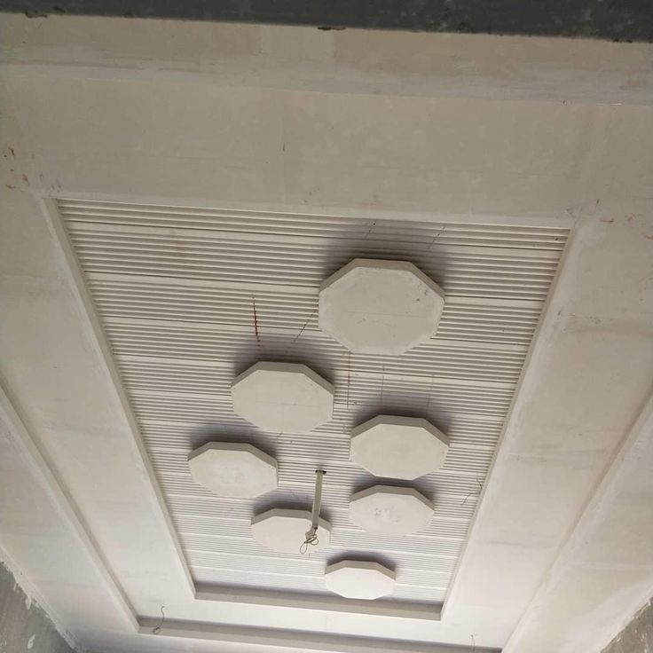 the ceiling is covered in white paint and has four round holes on it, which are connected to wires