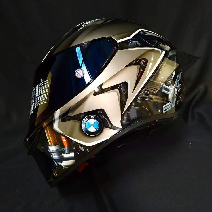 the helmet is designed to look like it has been painted gold and black with blue accents