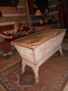 an old wooden table sitting on top of a rug in a room with teddy bears