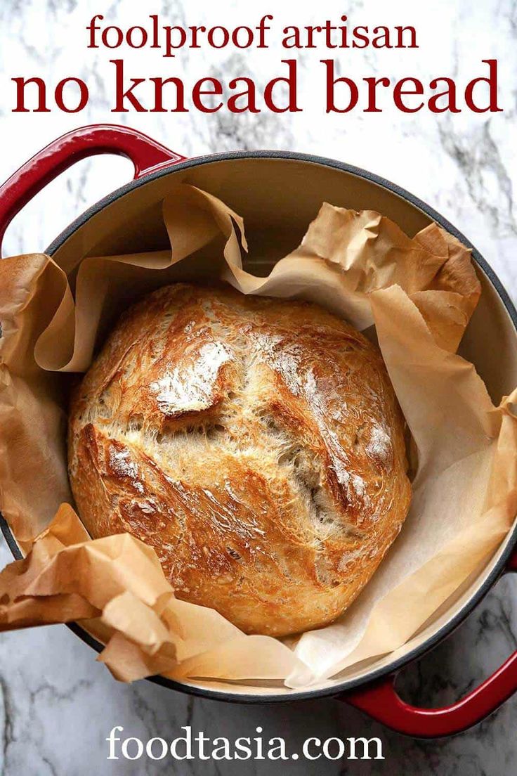 a loaf of artisan no knead bread in a red pot with text overlay