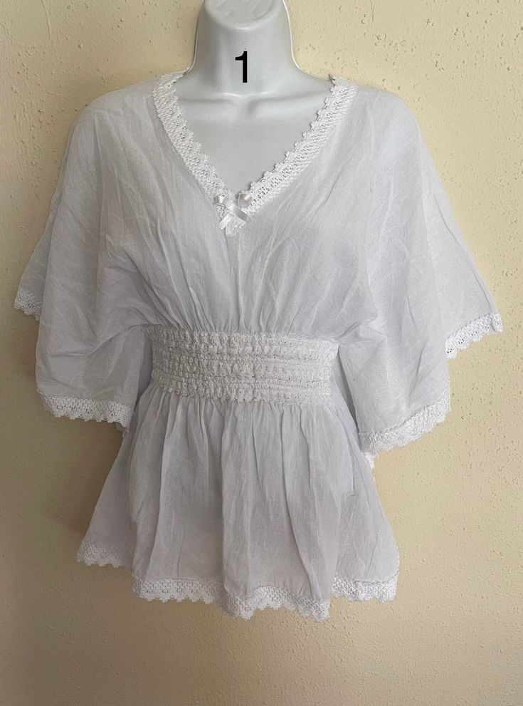 This beautiful artisanal blouse is made in Oaxaca, Mexico. The blouse has a loose-fitting and it has embroidery around it. Feel free to contact if you have any questions! White Folk Style V-neck Blouse, Flowy Cotton V-neck Blouse, Embroidered V-neck Top For Daywear, Flowy Smock Blouse, V-neck Embroidered Blouse For Vacation, Embroidered V-neck Peasant Top For Beach, Elegant Embroidered Tops With Relaxed Fit, Traditional V-neck Spring Blouse, Cotton V-neck Blouse For Vacation