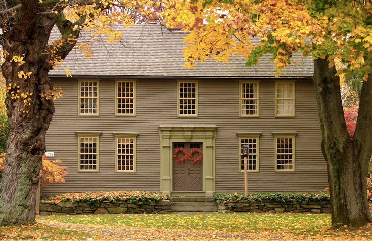 a house in the fall with leaves on the ground