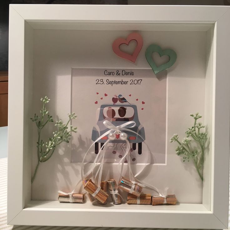 a white frame with some wine corks in front of it and two hearts on the back