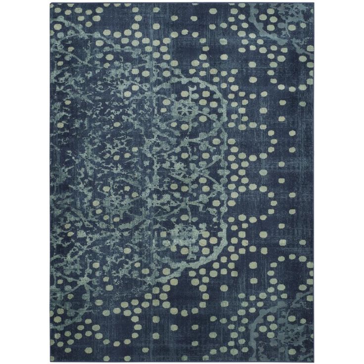 a blue rug with white dots on the top and an intricate design in the middle