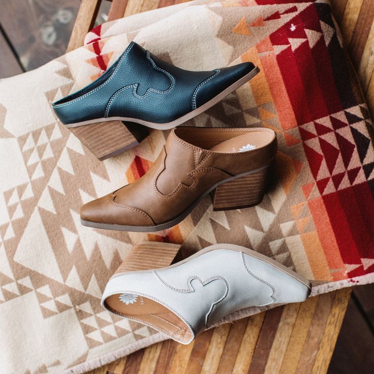 Introducing CYAN, a timeless western-inspired mule, featuring a genuine leatherstack heel, a pointed snip toe design, and contrast top-stitching - it is an essential style every closet needs. Closure: slip-on Toe Shape: pointed Heel Height: 2.25 inches Platform Height: .25 inches Materials: faux leather Insole: padded removable insole Outsole: rubber Womens Mules Shoes, Outfits With Mules Heels, Outfits With Mules, Mules Shoes Heels, Western Mules, Closet Needs, Heeled Mule, Contrast Top, Clog Heels