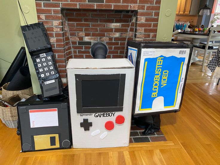 an old fashioned gameboy sitting on top of a wooden floor in front of a fireplace