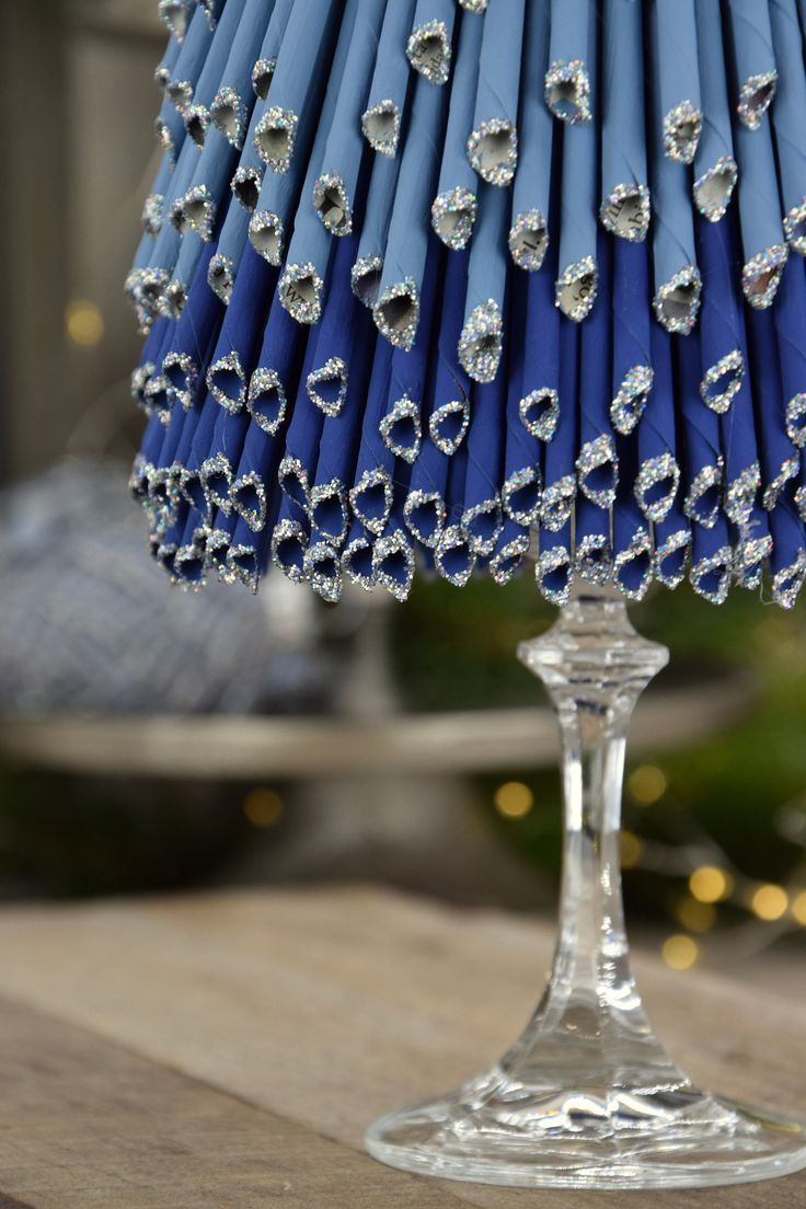 a blue lamp shade sitting on top of a wooden table