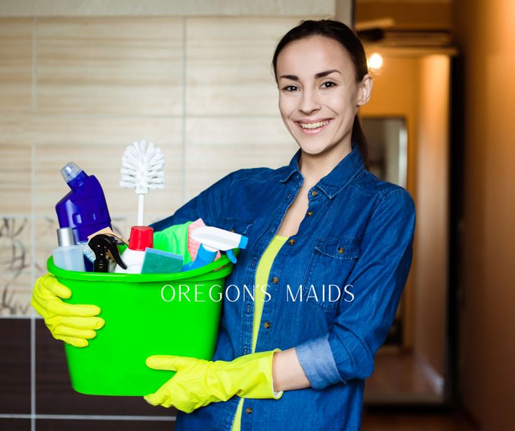 a woman holding a bucket full of cleaning supplies