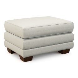 a white ottoman sitting on top of a wooden base