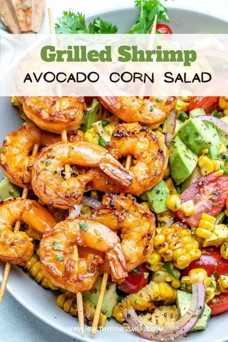 grilled shrimp and avocado corn salad in a bowl with toothpicks