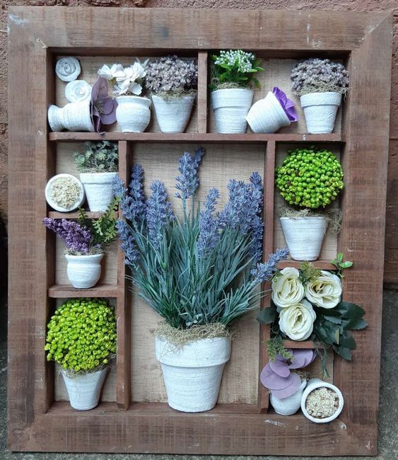 a wooden box filled with lots of potted plants