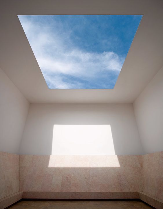 an empty room with a skylight above it