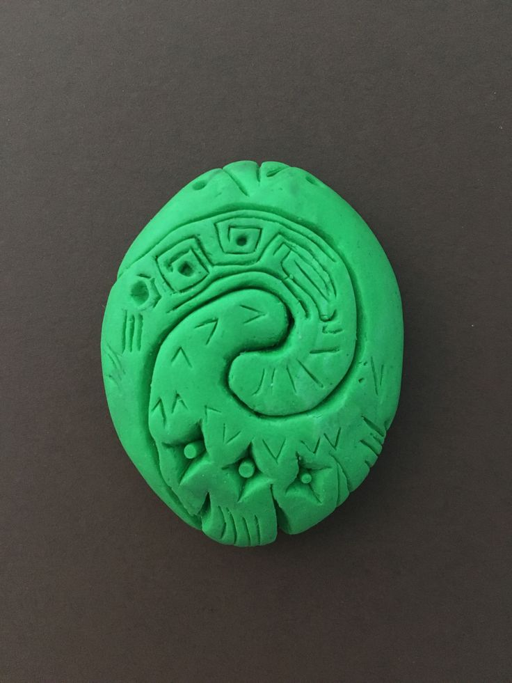 a green carved object sitting on top of a table