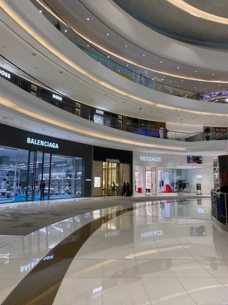 the inside of a mall with people walking around