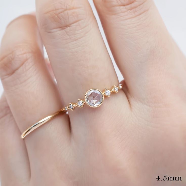 ✦ Current Inventory✦ 0.10ct yellow gold ring and 0.30ct yellow gold ring are in-stock in size 7. These will ship immediately in size 7, other sizes require 10 days to resize. Everything else is made-to-order and it takes 4 weeks. ✦ Main listing photo features 4.5mm diamond ring ✦ Video features top: 0.16ct diamond and bottom: 0.30ct Diamond ✦ Focal stone: natural rose-cut diamond ✦ GIA cert is optional 200) ✦ Bandwidth: approx. 1.4mm ✦ Accented with 0.05ctw natural earth-mined diamonds ✦ Low profile bezel setting ✦ Recycled solid 14k gold ✦ Packaged in a velvet ring box ✦ Handmade in NYC❤️ ✦ Buy this ring and receive 5% off coupon on your next purchase! 💎Focal Stone Size ✦ Near colorless, VS clarity, eye clean ✦ ≈4.0mm ≈0.10-0.20ct ✦ ≈4.5mm ≈0.20-0.30ct ✦ ≈5.0mm ≈0.30-0.35ct ✦ Please inqu Delicate Gold Stackable Rings With Rose Cut Diamonds, Diamond Birthstone Ring With Rose Cut In Open Style, Open Ring With Rose Cut Diamonds Birthstone, Open Ring Birthstone Ring With Rose Cut Diamonds, Birthstone Open Ring With Rose Cut Diamonds, Delicate Rose Gold Stackable Rings With Diamond, Open Birthstone Ring With Rose Cut Diamonds, Delicate Rose Cut Diamond Proposal Ring, Dainty Promise Birthstone Ring With Rose Cut Diamonds