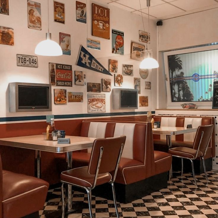 the interior of a restaurant with checkered flooring and retro style booths set up for diners