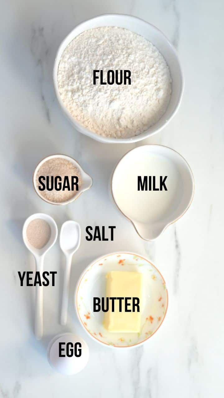 ingredients to make an egg cake laid out on a white marble counter top with the words flour, sugar, salt, butter, and eggs