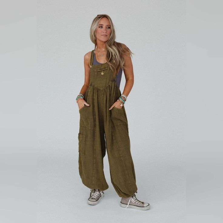 Get ready to look effortlessly boho - chic and ready - to - go in the Coastal Muse Wide Leg Jumpsuit! Feel authentically you in this cute jumpsuit because it features: Comfortable, lightweight, mineral - washed Cotton gauze fabric Loose and slouchy jumpsuit overall silhouette Classic square neckline with adjustable button straps Flattering gathered pointed center seams Oversized wide pant legs with unique tied gathered details along the ankles Convenient side pockets, a single cargo pocket along the side, and a center pocket along the bib Pair with: Eye Of The Sun Padded Bralette, Cherish The Moment Lace Top and Neon Lights Stacked Bracelet. *Due to lighting and differences in monitors, actual colors may vary slightly from what appears online. Model is 5'8" and wearing a size Small. Approx Relaxed Fit Vacation Overalls With Pockets, Relaxed Fit Overalls With Pockets For Vacation, Relaxed Fit Overalls For Spring Vacation, Casual Khaki Jumpsuits And Rompers For Summer, Relaxed Fit Overalls For Vacation, Casual Relaxed Fit Overalls For Vacation, Bohemian Relaxed Fit Jumpsuits And Rompers For Loungewear, Bohemian Cotton Jumpsuits And Rompers With Relaxed Fit, Bohemian Relaxed Fit Overall Jumpsuit