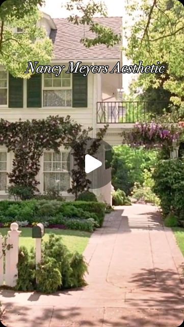 a white house surrounded by trees and bushes