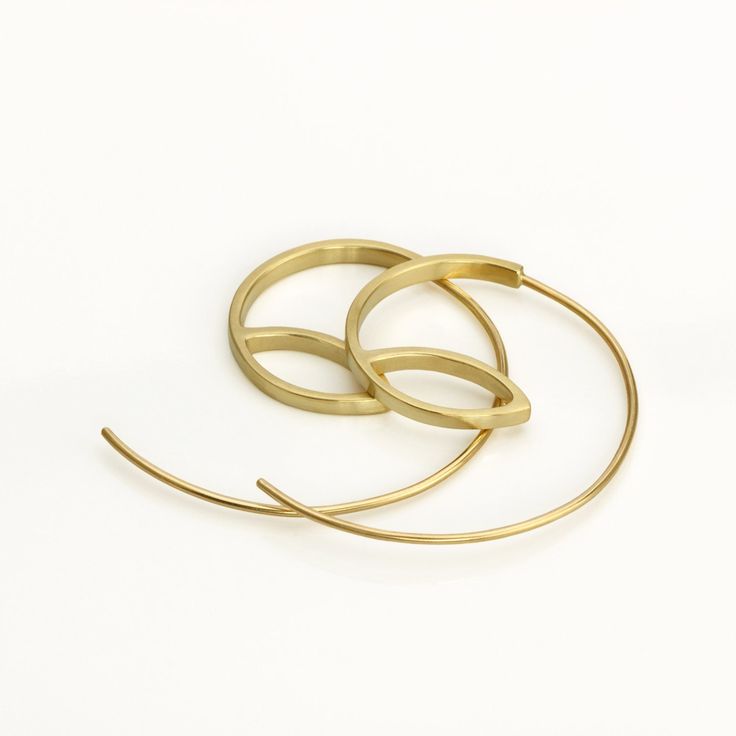 These are minimalist delicate gold hoop earrings, handmade of yellow 14k solid gold. I made these gold hoops of a rectangle gold wire, 2 mm wide x 1 mm thick. They have a delicate matte finish. Width of the delicate long ear wire (the wire that goes into the ear lobe) is 0.8 mm = about 0.3 inch.  These modern hoops are unique, and will add chic to any outfit. They are perfect for everyday's wear, as well as for a night out.  Elegant, minimal and eye catching. Total length of the earrings is 3.1 Modern Yellow Gold Wrap Earrings, Minimalist Yellow Gold Hoop Earrings, Modern Yellow Gold Small Hoop Wrap Earrings, Minimalist Tarnish Resistant Yellow Gold Wrap Earrings, Minimalist Small Hoop Earrings In Recycled Gold, Minimalist Handmade Gold Plated Hoop Earrings, Minimalist Handmade Gold-plated Hoop Earrings, Modern Yellow Gold Hoop Wrap Earrings, Modern Hoop Earrings In Recycled Gold