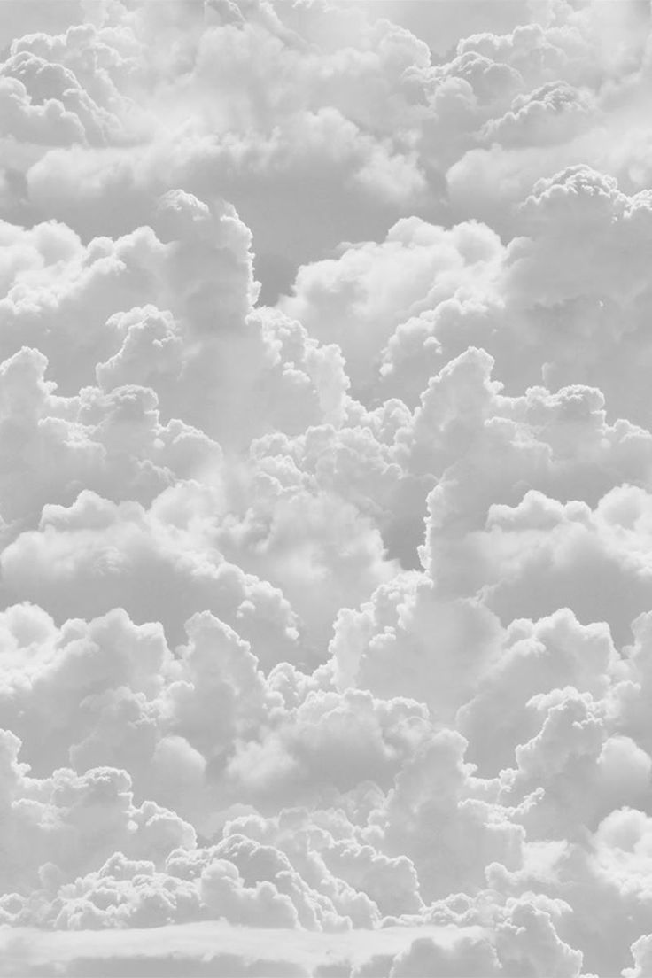 black and white photograph of clouds in the sky from an airplane window, looking down