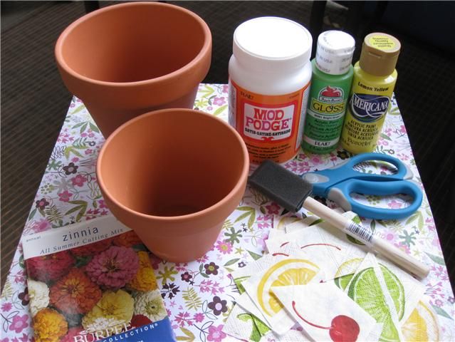 three flower pots sitting on top of a table next to some glue and other crafting supplies