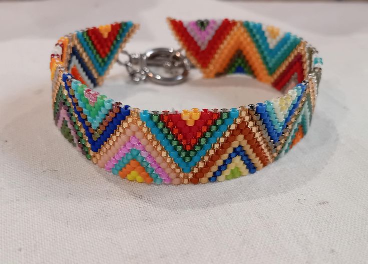 Lightweight and easy to wear multi-color woven bead bracelet. It goes with all your outfits thanks to its wide mix of colors. On T clasp, design and elegant. Festival Multicolor Beaded Braided Bracelets, Adjustable Multicolor Jubilee Cuff Bracelet, Multicolor Beads Bangle For Friendship, Multicolor Braided Bead Bangle Bracelet, Multicolor Woven Braided Bracelets With Round Beads, Multicolor Braided Bracelet Bangle, Multicolor Beaded Braided Bracelets, Multicolor Woven Beaded Bracelets For Gifts, Multicolor Woven Braided Bracelets