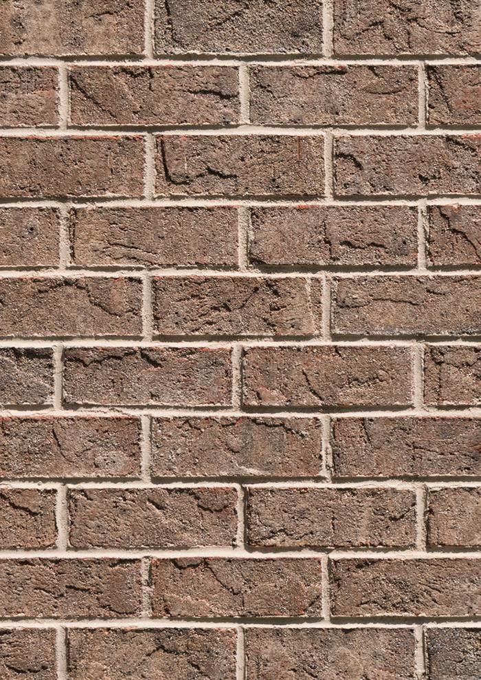 a brick wall that is brown and has no mortars or mortars on it