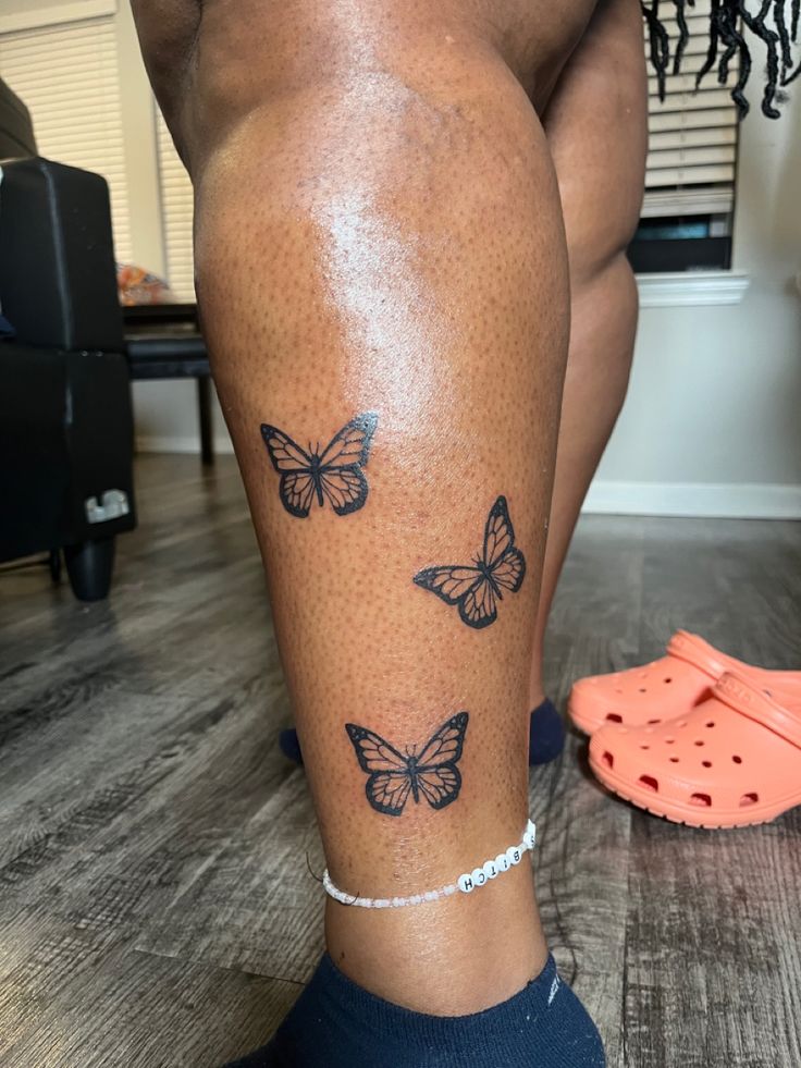 a woman's legs with butterflies on them