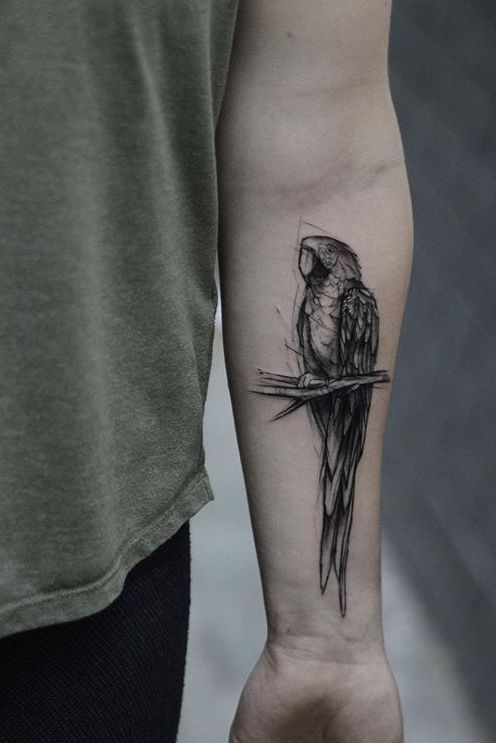 a black and white bird tattoo on the arm