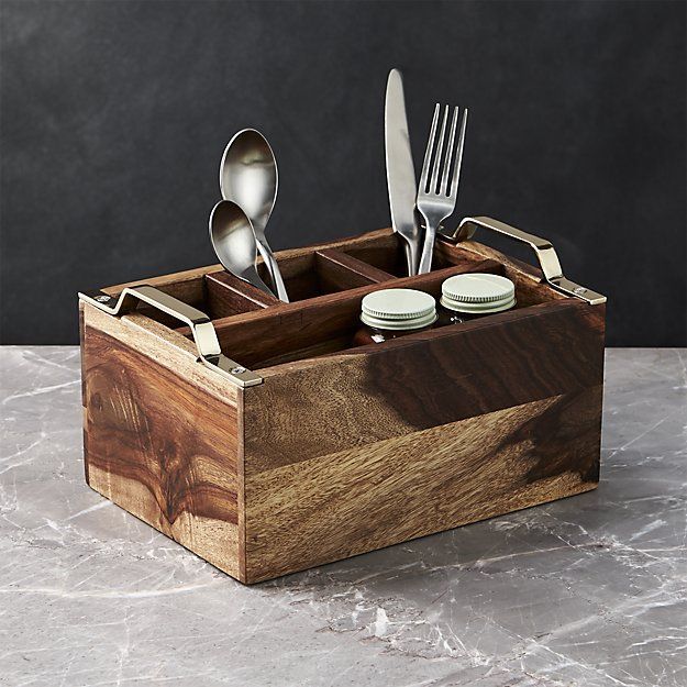 a wooden box with utensils and spoons in it on a marble surface