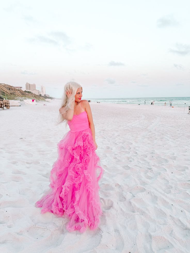 Make a splash in the Pink Jelly Dress from Sassy Shortcake! This playful, strapless maxi dress is perfect for any occasion. With its stunning pink color and layers of tulle ruffles, you'll be the center of attention. And with a hidden back zipper, you'll have a flawless, effortless look. Lined. Fits true to size. Model is 5'3 wearing a size small. content: 95% polyester, 5% spandex Pink Ruffled Dress For Gala, Pink Ruffled Maxi Dress For Gala, Fitted Pink Maxi Dress With Ruffled Skirt, Pink Strapless Maxi Dress For Spring, Pink Sleeveless Tulle Maxi Dress, Pink Tiered Maxi Dress With Ruffled Skirt, Sleeveless Pink Tulle Maxi Dress, Spring Tulle Maxi Dress With Ruffles, Flirty Pink Ruffled Maxi Dress