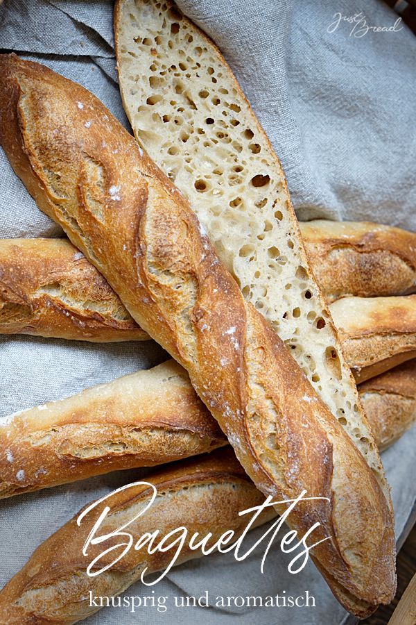 several loaves of bread sitting on top of each other in a basket with the words baguettes