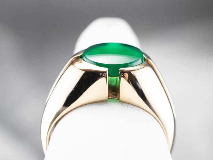 This retro era ring has a marvelous architecture to it! Structured lines and accents give this ring height and dimension that catches the light. The stone, a forest green onyx, fills with light around the edges, almost as if it were glowing! Metal: 14K Yellow Gold Gem: Green Onyx Gem Measurements: 9.8 mm, Round Ring Size: 7.50 Marks: "K 14K" Stamped on the inside band Yellow Gold Sapphire Ring, Green Stone Ring, Retro Era, Green Stone Rings, Onyx Jewelry, Cameo Ring, Round Rings, Onyx Ring, Green Onyx