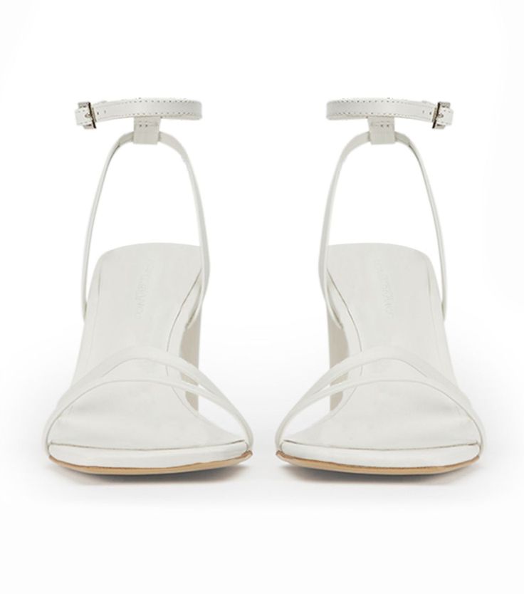 Introducing the forever classic Corso strappy heels in white leather. Designed with slender foot-framing straps, an adjustable and secure ankle strap, mid-height block heel, she remains a timeless staple. -Material: Leather Upper & Lining -Sole: Rubber -Fit: True to size -Toe-shape: Squared toe-shape -Heel: 8.5cm Classic White High Heel Sandals, Classic White Heels With Single Toe Strap, Classic White Sandals With Sculpted Heel, Classic White Sandals With Heel Strap, Classic Heels With Wrapped Block Heel, Classic White Sandals With Wrapped Heel, White Block Heels With Stacked Heel, White Sandals With Stacked Heel And Single Toe Strap, White Ankle Strap Sandals With Reinforced Heel