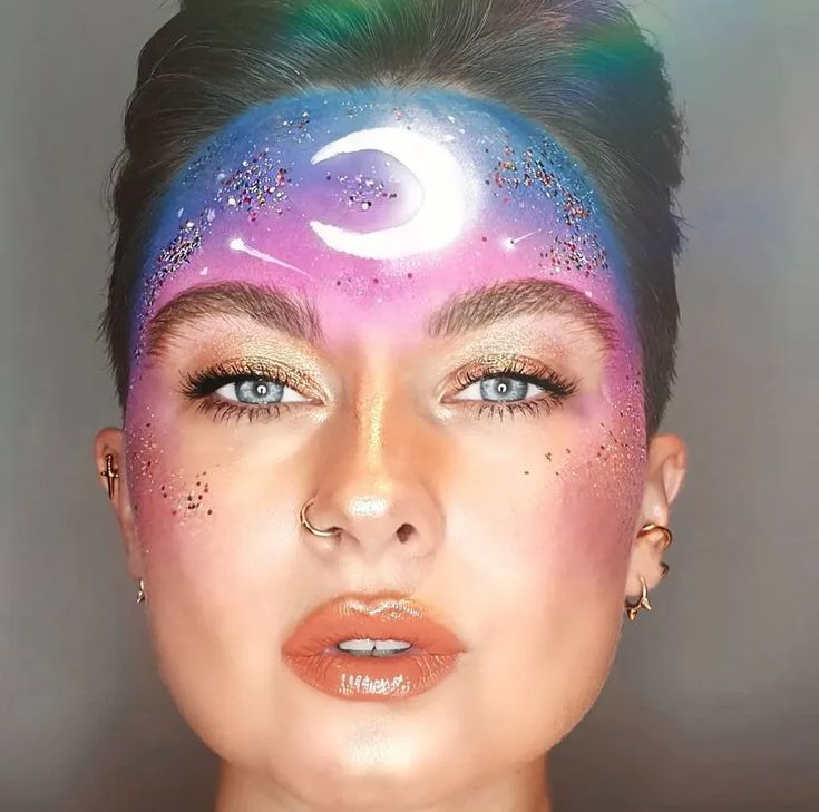 46 Halloween 2021 Face Paint Ideas That Will Make You Want To Get Extra With Makeup Again — See Photos | Allure Halloween Glitter Makeup, Alien Face Paint, Halloween Face Paint Ideas, Cosmic Makeup, Blue Face Paint, Halloween Face Paint, Face Paint Ideas, Eco Glitter, Galaxy Makeup