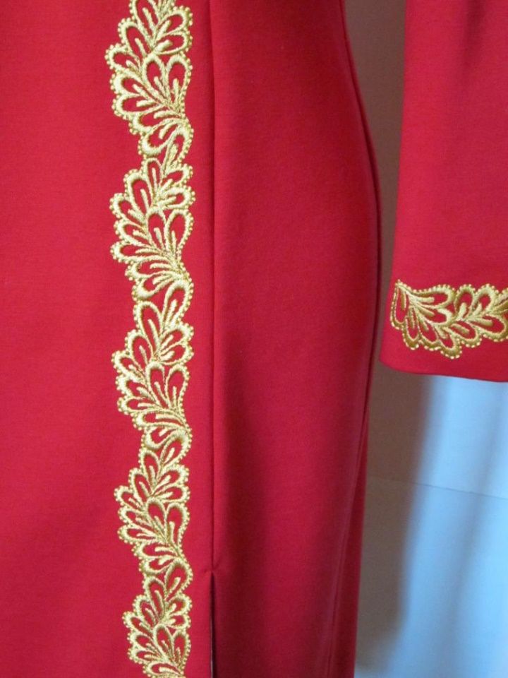 the back of a red suit with gold embroidery on it