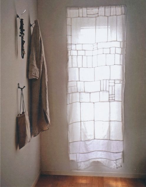 a bathroom with two towels hanging on the wall and a towel rack in front of it