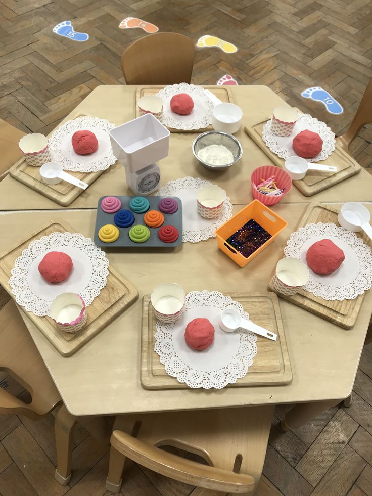 the table is set with cupcakes and other items