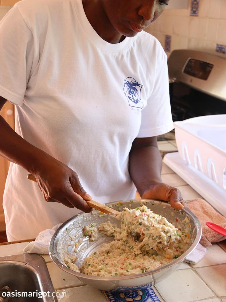 a woman in a white shirt is making food