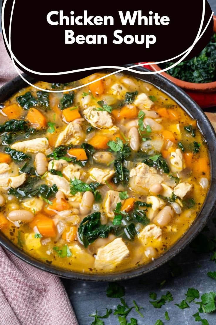 chicken white bean soup with spinach and carrots in a bowl on a table