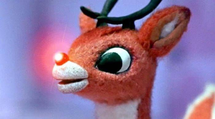 a close up of a stuffed animal with big eyes and antlers on it's head