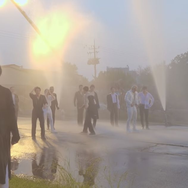 a group of people walking down a street next to a fire hydrant