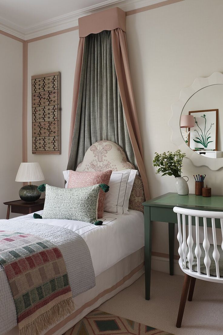 a white bed sitting next to a green table