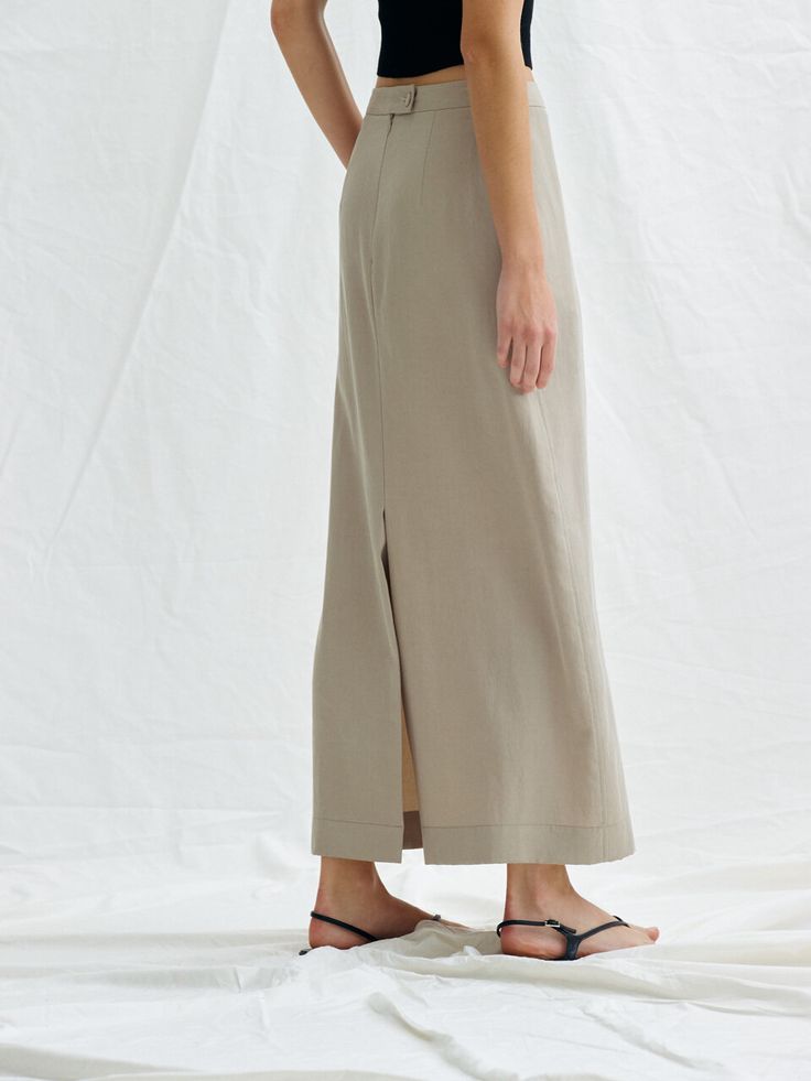 Editor's NotesThis is a chic mood maxi skirt. It is an attractive item with a vintage color feeling made of washed tencel material in a minimalistic design.- Creates a feminine silhouette with high waist and H-line.- It is natural and stylish with a falling texture.- Skirts with side pockets, covered button on the back and zipper closure- There is a back opening to add activity*The color of the image may differ from the actual color depending on the resolution of your monitor.Measurements (inch) Spring Relaxed Maxi Skirt, Solid Color Midi Length Bottoms For Summer, Beige Midi Length Bottoms For Daywear, Casual Midi-length Bottoms With Side Slits, Beige Maxi Length Lined Skirt Bottoms, Chic Midi-length Bottoms With Side Slits, Beige Maxi Length Spring Bottoms, Beige Maxi Length Bottoms For Spring, Spring Workwear Maxi Skirt Full Length