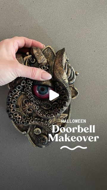 someone is holding an object with their thumb on it and pointing to the screen that reads halloween doorbell makeover