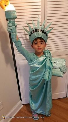 a young boy dressed as the statue of liberty