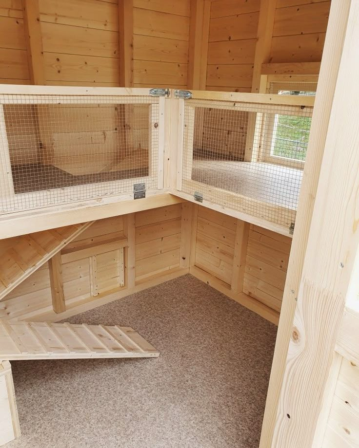 the inside of a chicken coop with wooden walls