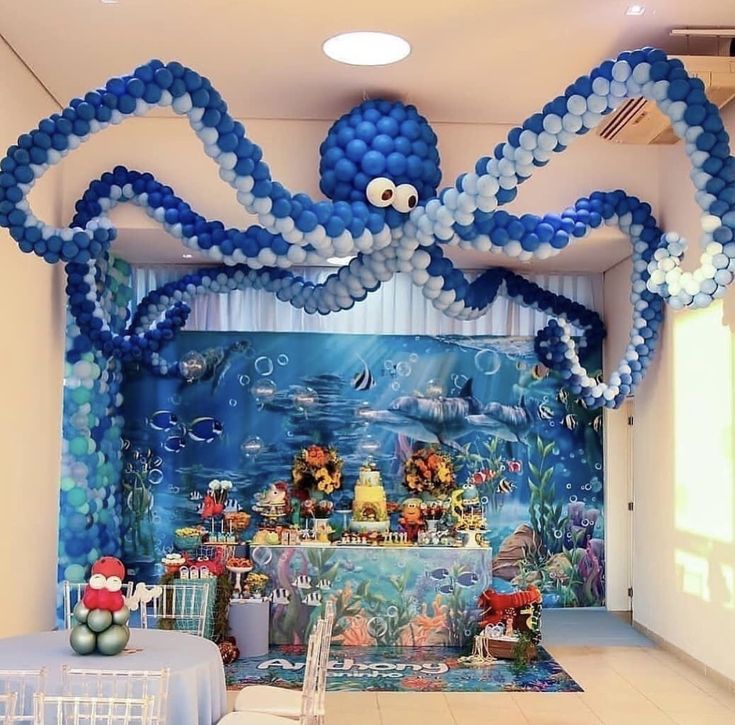 an under the sea themed birthday party with balloons, decorations and table cloths on display